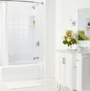 a light-filled bathroom with elegant bathtub and tile surround