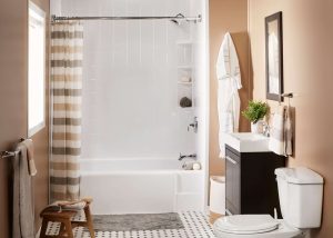 a newly installed bathtub with tile surround in light-brown-toned bathroom